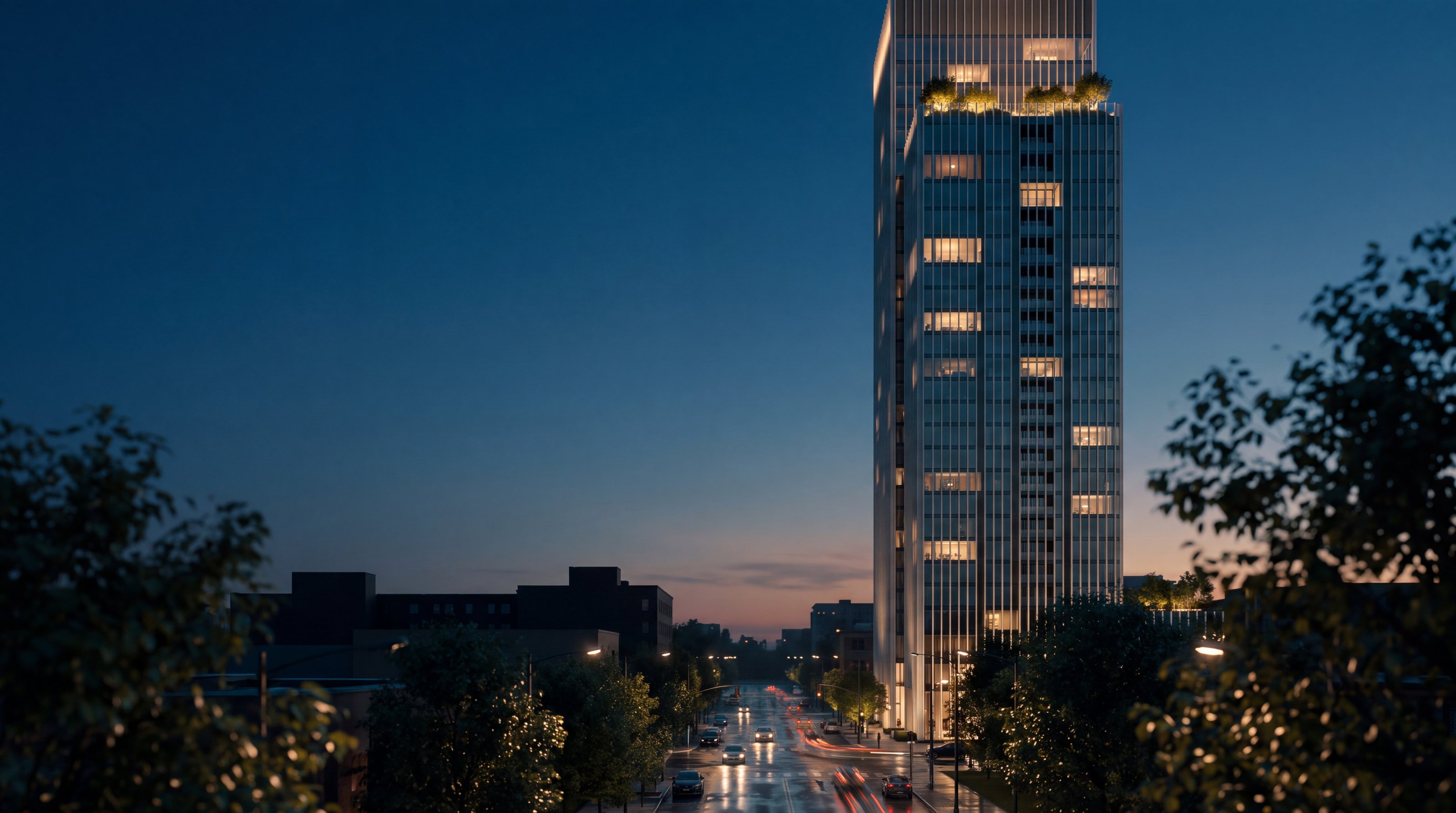 A residential tower at blue hour, lit apartments above a quiet boulevard